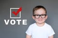 Cute Kid encouraging others to register and vote Royalty Free Stock Photo