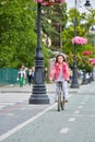 Cute kid girl in blue helmet going to ride her bike Royalty Free Stock Photo