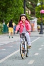 Cute kid girl in blue helmet going to ride her bike Royalty Free Stock Photo