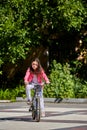 Cute kid girl in blue helmet going to ride her bike Royalty Free Stock Photo