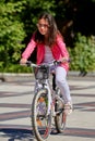 Cute kid girl in blue helmet going to ride her bike Royalty Free Stock Photo