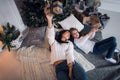 Cute kid girl and her mom playing under christmas tree with presents, lying on wooden floor in room. Wearing trendy Royalty Free Stock Photo