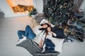 Cute kid girl and her mom playing under christmas tree with presents, lying on wooden floor in room. Wearing trendy Royalty Free Stock Photo