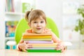 Cute kid girl preschooler with books