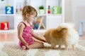 Cute kid girl sitting on the floor with her dog Royalty Free Stock Photo