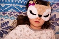 Cute kid girl sleeping in an owl sleep mask Royalty Free Stock Photo