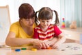 Cute kid girl at speech therapist office Royalty Free Stock Photo