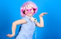 Cute kid with headphones blue background. Small girl headphones pink wig dancing. Child using technology for fun. Modern Royalty Free Stock Photo