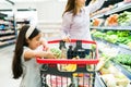 Cute kid helping mom shopping groceries Royalty Free Stock Photo