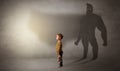 Cute kid with hero shadow behind Royalty Free Stock Photo