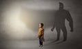 Cute kid with hero shadow behind Royalty Free Stock Photo