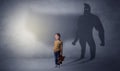 Cute kid with hero shadow behind Royalty Free Stock Photo