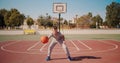 Cute kid hiting a basketball ball. Boy practicing shooting a basketball.