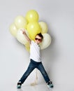 Cute kid holding a lot of balloons