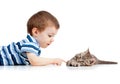 Cute kid lying on floor and playing with cat pet Royalty Free Stock Photo