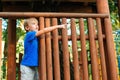 Cute kid playing in tree house on backyard. Happy childhood. Summer holidays concept. Tree house for kids. Happy boy plays in an Royalty Free Stock Photo