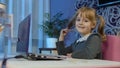 Cute kid pupil watching video lesson, studying using digital laptop computer, doing homework online