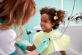 Cute kid show her teeth to dental assistant Royalty Free Stock Photo