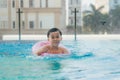 Cute kid swimming in a pool with clear water Royalty Free Stock Photo