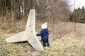 Toddler boy playing with concrete anti-tank barriers from World War Two