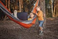 Cute kid using digital gadget for reading and learning in hammock, online education Royalty Free Stock Photo