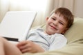 Cute kid using laptop computer smiling Royalty Free Stock Photo