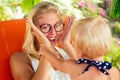 Cute kid and young blonde female parent playing hide and seek making a joke.Woman and little fair-haired girl year old Royalty Free Stock Photo