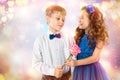 Cute kids, boy gives a flower little girl. Valentine`s Day. Child love Royalty Free Stock Photo