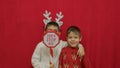 Cute kids brothers hugging and showing santa stop here sign. Christmas celebration and happy family.