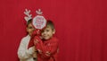 Cute kids brothers hugging and showing santa stop here sign. Christmas celebration and happy family. Royalty Free Stock Photo