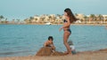 Cute kids building sand castle at sea bay. Happy children having fun at beach. Royalty Free Stock Photo