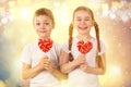 Cute kids little boy and girl with candy red lollipop in heart shape. Valentine`s day art portrait. Royalty Free Stock Photo