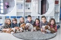 Cute kids lying on the floor with the puppies English bulldog Royalty Free Stock Photo