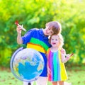 Cute kids playing with airplanes and globe Royalty Free Stock Photo