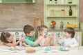 Cute kids playing Easter eggs at the table and laugh Royalty Free Stock Photo