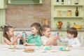 Cute kids playing Easter eggs at the table and laugh Royalty Free Stock Photo