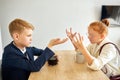 Cute kids quarelling at home sitting at table Royalty Free Stock Photo