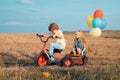 Cute kids on retro bike against blue sky background on field. Kids love. Kid having fun at countryside. Freedom for kids Royalty Free Stock Photo