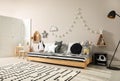 Cute kids room with stylish comfortable floor bed and toys. Montessori interior Royalty Free Stock Photo