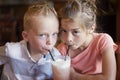 Cute kids sharing a mint Italian soda drink at a cafe Royalty Free Stock Photo