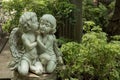 Cute kissed couple cupid in garden