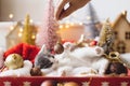 Cute kitten playing with christmas glitter bauble at christmas tree and decorations in lights Royalty Free Stock Photo