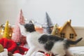 Cute kitten playing among christmas tree decorations, ornaments and warm lights Royalty Free Stock Photo