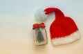 cute knitted santa hat next to mason jar with christmas tree