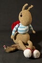 Cute knitted toy bunny with small driftwood - perfect for easter decorations