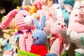 Cute knitted toys knitted hare sit together with other crochet toys on the weekend market.