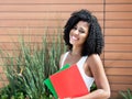 Cute latin female student woman with curly black hair