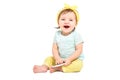 Cute laughing baby girl, sitting with a mobile phone