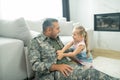 Cute laughing daughter feeling cheerful while playing with daddy Royalty Free Stock Photo