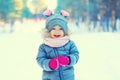 Cute laughing little child on snow walking in winter